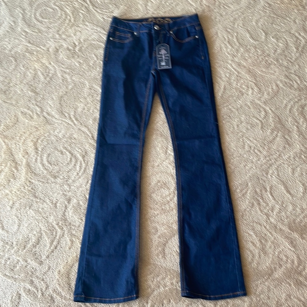 Premium wax, Jean. Brand new with original tags labeled a size 5.